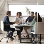 a group of people sitting around a table